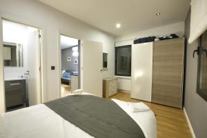 a bedroom with a large bed and a bathroom at Cuencaloft La Plazeta in Cuenca