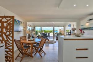 a kitchen and dining room with a table and chairs at Modern Beach Villa 1150 in Saint Martin