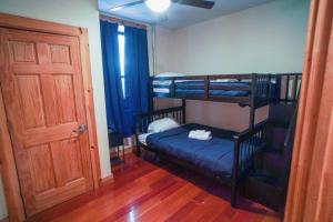 a room with three bunk beds and a door at Rustic Sunset in New York