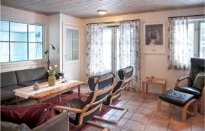 a living room with a couch and a table and chairs at Jervehiet - Hytte 4 in Øvre Ramse