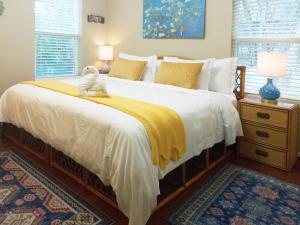 a bedroom with a large bed with a yellow blanket at King Bed in Relaxing Oasis, with FREE Snack/Wi-Fi/Parking in San Marcos