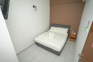 Postel nebo postele na pokoji v ubytování Gemilang Hotel Klang