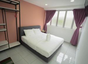 Postel nebo postele na pokoji v ubytování Gemilang Hotel Klang