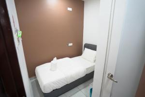 Postel nebo postele na pokoji v ubytování Gemilang Hotel Klang