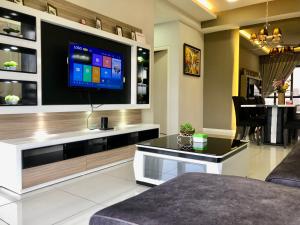 a living room with a flat screen tv on a wall at Takuro Homestay in Petaling Jaya