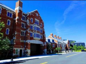 a red brick building with a tower on a street at Golden Gem in Heart of East Rock Quiet 3BR Near DT and Yale in New Haven
