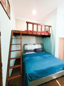 um quarto com 2 beliches e uma escada em Mawar Dayana Homestay em Jertih