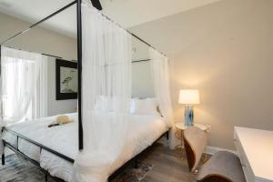 a bedroom with a canopy bed with a mirror at Modern 4BR Ground Level King Beds Steps 2 Beach C in Myrtle Beach