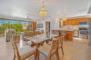 a kitchen and dining room with a table and chairs at WAILEA ELUA, #1509 condo in Wailea