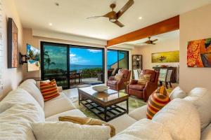 a living room with a couch and a table at MAKENA SURF, #G-101 condo in Wailea