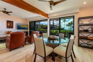 a dining room with a glass table and chairs at MAKENA SURF, #G-101 condo in Wailea