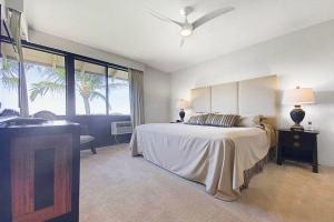 a bedroom with a bed and a sink in it at WAILEA GRAND CHAMPION, #148 condo in Wailea +21 photos