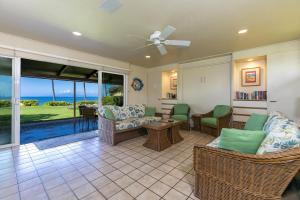 a living room with a view of the ocean at My Waii Beach Cottage home in Kihei