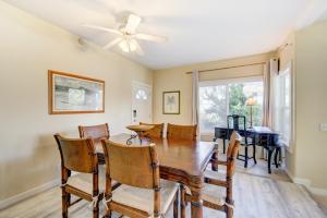 a dining room with a table and chairs and a ceiling fan at Kauai Regency at Poipu Kai by Coldwell Banker Island Rentals in Koloa
