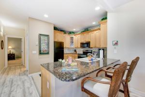 a kitchen with a counter with two chairs and a sink at Kauai Regency at Poipu Kai by Coldwell Banker Island Rentals in Koloa