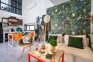 a living room with a couch and a table at Manao Seaview Pool Villa 32 - 5 Mins Walk To The Beach in Ko Lanta