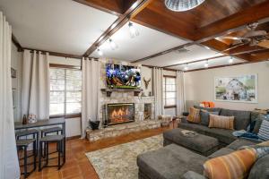 a living room with a couch and a fireplace at Gorgeous rustic home near River Walk and Sea World in San Antonio