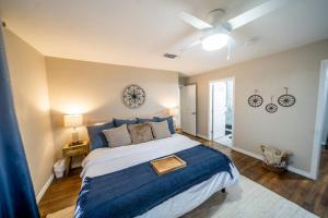 a bedroom with a large bed with a blue blanket at Gorgeous rustic home near River Walk and Sea World in San Antonio