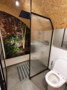 a bathroom with a shower stall and a toilet at La Levée Resort in Sai Yok