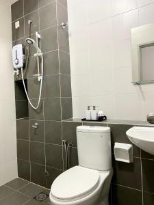 a bathroom with a shower and a toilet and a sink at Melur Homestay in Setia Alam