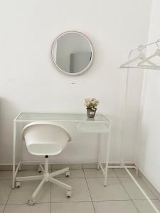 a white desk with a white chair and a mirror at Melur Homestay in Setia Alam