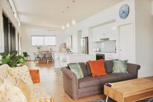 a living room with a couch and a table at TWO PELICANS Island Beach in Island Beach