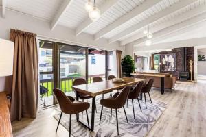 a dining room with a table and chairs at Family Retreat close to City - WiFi Netflix Garden in Auckland