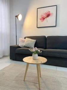 a living room with a couch and a coffee table at Melur Homestay in Setia Alam