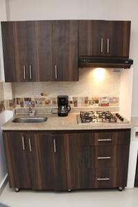 a kitchen with a sink and a stove top oven at CASA ESTADIO MEDELLIN ! Apartamentos RENOVADOS en EXCELENTE UBICACION Laureles Estadio in Medellín