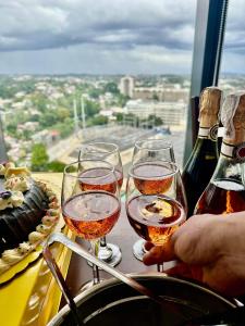 three glasses of wine on a table with a view at AEON Towers Davao in Davao City