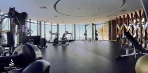 a gym with treadmills and exercise equipment in a building at Apartement Borneo Bay Tower kartanegara Balikpapan in Balikpapan