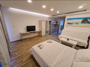 a living room with a bed and a couch at BRiGHT AND COZY STUDIO SUiTE EiLAT in Eilat