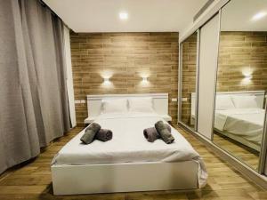 a bedroom with a large white bed with mirrors at BRiGHT AND COZY STUDIO SUiTE EiLAT in Eilat