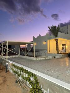 a house with a parking lot in front of it at مزرعة وفيلا الريان وادي رم in Ruʼaysat al Khālidī