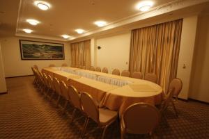 a conference room with a long table and chairs at caravan Hotel Addis in Addis Ababa