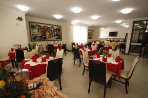 a dining room with red tablecloths and chairs at caravan Hotel Addis in Addis Ababa