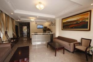 a living room with a couch and chairs and a table at caravan Hotel Addis in Addis Ababa +11 photos