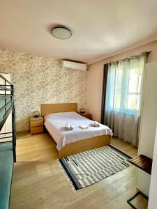 a small bedroom with a bed and a window at Studio Thermi 1 in Varna City