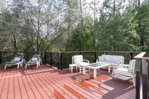 a deck with rocking chairs and a table and chairs at Happy Trails - Updated 3-Bedroom Home with Cozy Sunroom and Spacious Deck home in Groveland