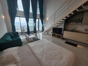a bedroom with a large bed and a staircase at Sunrise Gurney Premium Executive City/Seafront suite - Penang in George Town +72 photos