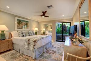 a bedroom with a bed and a flat screen tv at WAILEA ELUA, #1403 condo in Wailea +29 photos