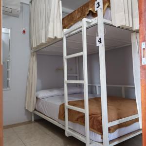 a bedroom with bunk beds in a hostel at BSH (Bu Sud's House) Yogyakarta in Yogyakarta