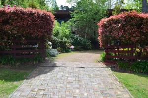 a brick path leading to a garden with flowers at Cloudland Garden Oasis in Blackheath