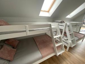a room with two bunk beds and a window at Villa Norda Dębki in Dębki
