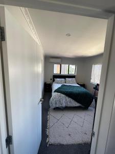 a small bedroom with two beds and a window at Auckand Holiday in the Golden Circle in Auckland
