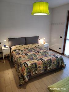a bedroom with a bed with a quilt on it at CASA VACANZE DA RIKI APPARTAMENTO 1 in Peschiera del Garda +25 photos