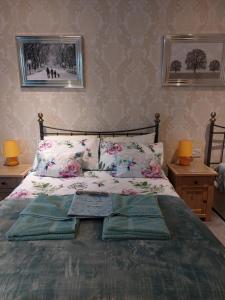 a bedroom with a bed with three pillows on it at PONDEROSA in Blackpool