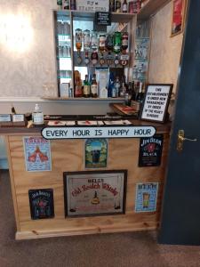 a counter in a bar with posters on it at PONDEROSA B&B with free onsite parking and breakfast included in Blackpool +55 photos