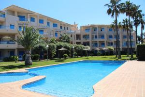 a large swimming pool in front of a building at Las Dunas 02 in Denia