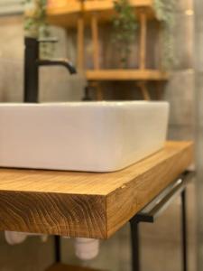 a white sink sitting on top of a wooden counter at Smart Art :) z bezpłatnym parkingiem podziemnym in Kielce
